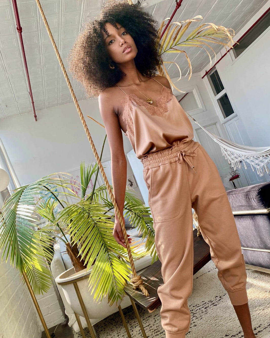 Model wearing a rose gold jumpsuit outfit