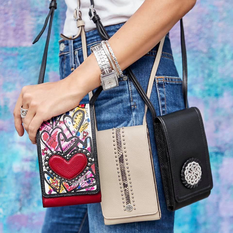 Model holding three small bags, colorful, nude color, and black