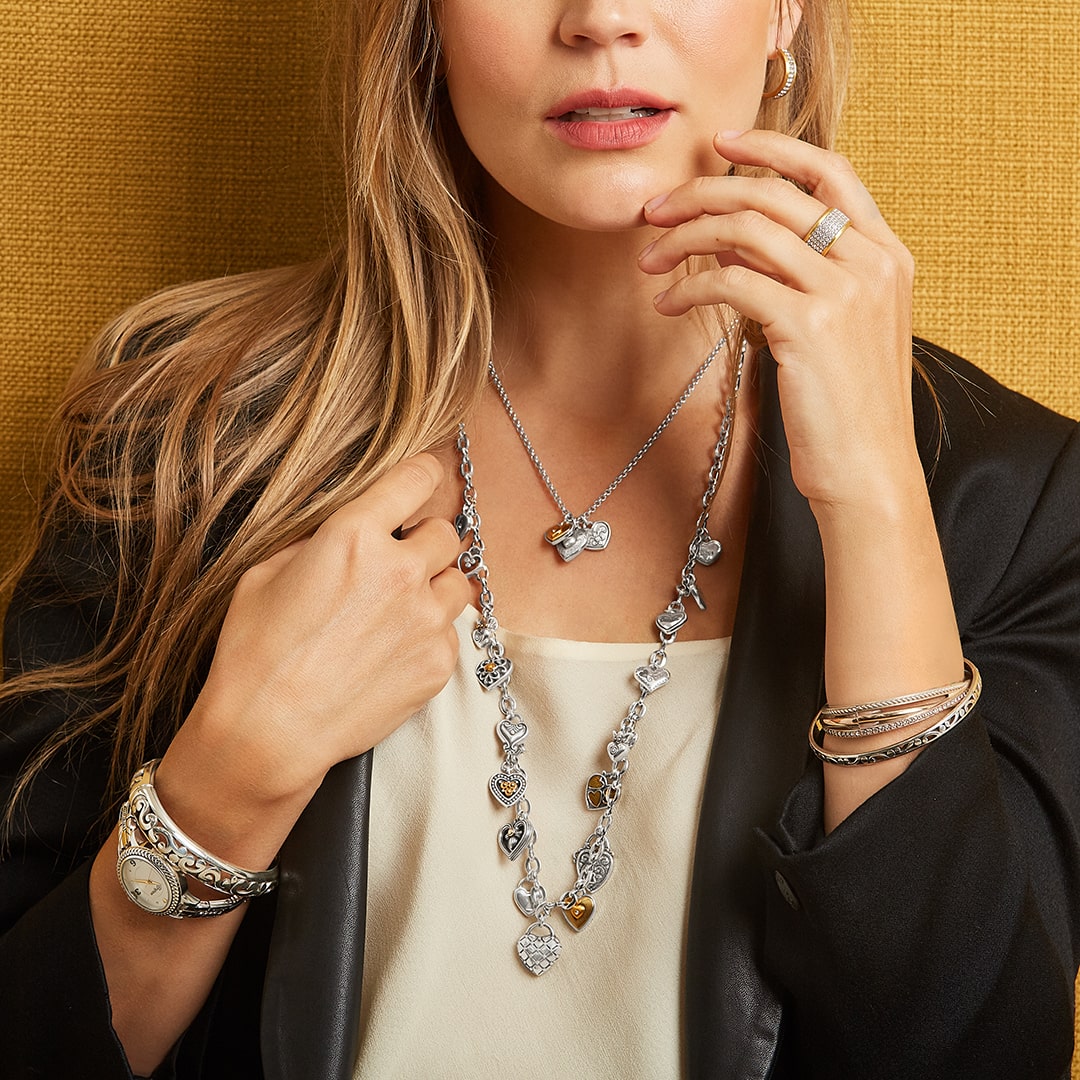 Model wearing bracelets, necklace, and rings