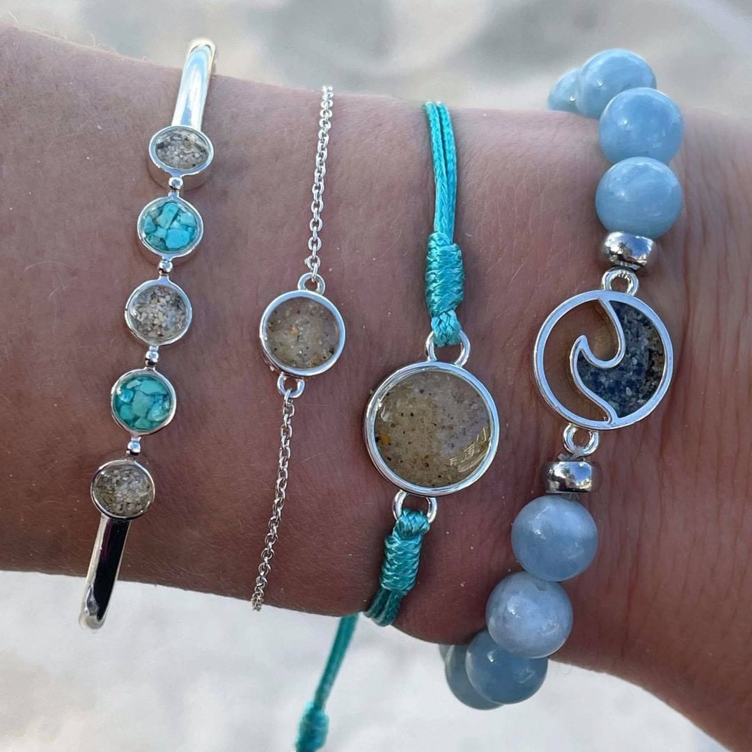 Assortment of blue bracelets on models wrist